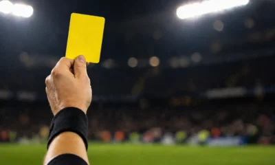 Cartellino giallo in mano all'arbitro